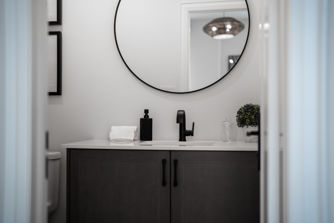 modern-bathroom-vanity-with-a-round-mirror-above-mgdy-p-o-vo